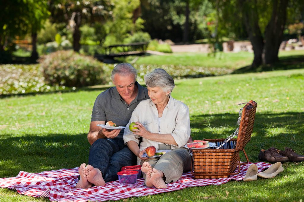 Elderly couple  picnicking in the garden